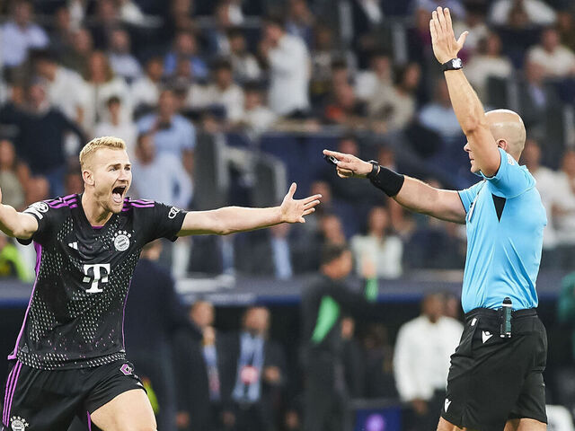 MADRID, SPAIN - MAY 8: Matthijs de Ligt of Bayern Muenchen and referee Szymon Marciniak during the UEFA Champions League semi-final second leg match between Real Madrid and FC Bayern München at Estadio Santiago Bernabeu on May 8, 2024 in Madrid, Spain.