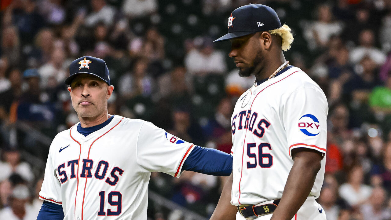 HOUSTON, TEXAS - MAY 14: Ronel Blanco #56 is walked off the field by Joe Espada #19 of the Houston Astros after being ejected in the fourth inning against the Oakland Athletics at Minute Maid Park on May 14, 2024 in Houston, Texas.
