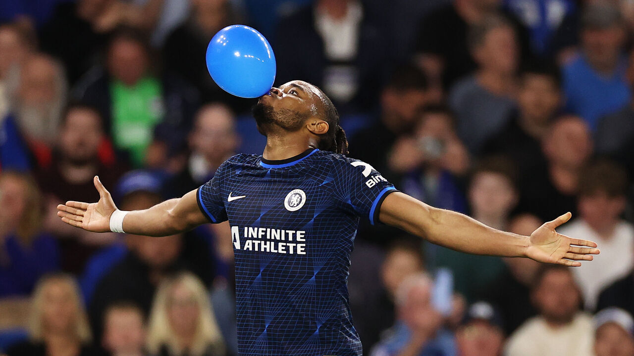 BRIGHTON, ENGLAND - MAY 15: Christopher Nkunku of Chelsea celebrates scoring his team's second goal with a balloon during the Premier League match between Brighton & Hove Albion and Chelsea FC at American Express Community Stadium on May 15, 2024 in Brighton, England.