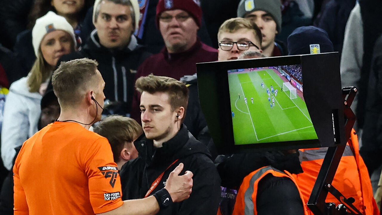 Referee Craig Pawson checks the VAR to disallow the goal of Chelsea's French defender #02 Axel Disasi due to an offside position during the English Premier League football match between Aston Villa and Chelsea at Villa Park in Birmingham, central England on April 27, 2024.