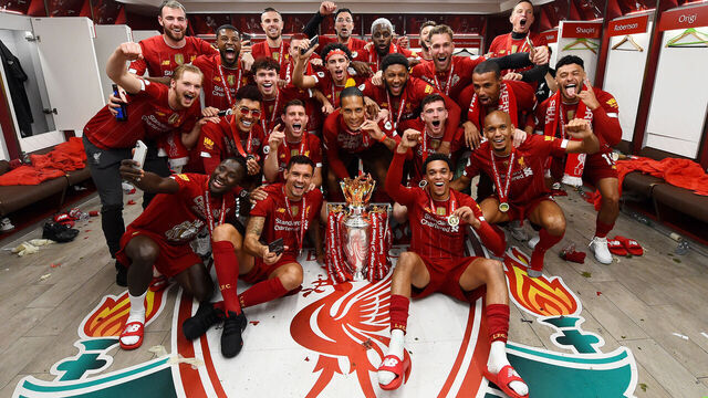 LIVERPOOL, ENGLAND - JULY 22: (THE SUN OUT, THE SUN ON SUNDAY OUT) Trent Alexander-Arnold, Georginio Wijnaldum, Naby Keita, Roberto Firmino, Alex Oxlade-Chamberlain, Fabinho, Andy Robertson, Virgil van Dijk, James Milner, Joe Gomez, Curtis Jones, Adrian, Divock Origi, Adam Lallana, Harvey Elliott, Joel Matip, Xherdan Shaqiri, Jordan Henderson captain of Liverpool and Jurgen Klopp manager of Liverpool celebrating in the dressing room with the premier league trophy after winning the Premier league at the end of the Premier League match between Liverpool FC and Chelsea FC at Anfield on July 22, 2020 in Liverpool, England. Football Stadiums around Europe remain empty due to the Coronavirus Pandemic as Government social distancing laws prohibit fans inside venues resulting in all fixtures being played behind closed doors.