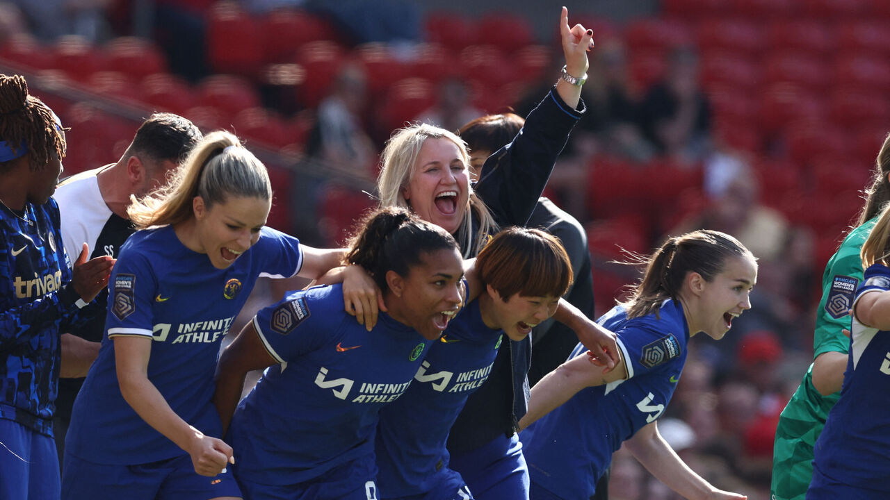 Chelsea's English manager Emma Hayes (C) and players react to their win on the touchline on the final whistle in the English Women's Super League football match between Manchester United and Chelsea at Old Trafford in Manchester, north west England, on May 18, 2024. Chelsea won the game 6-0 and secured their fifth league title in a row.