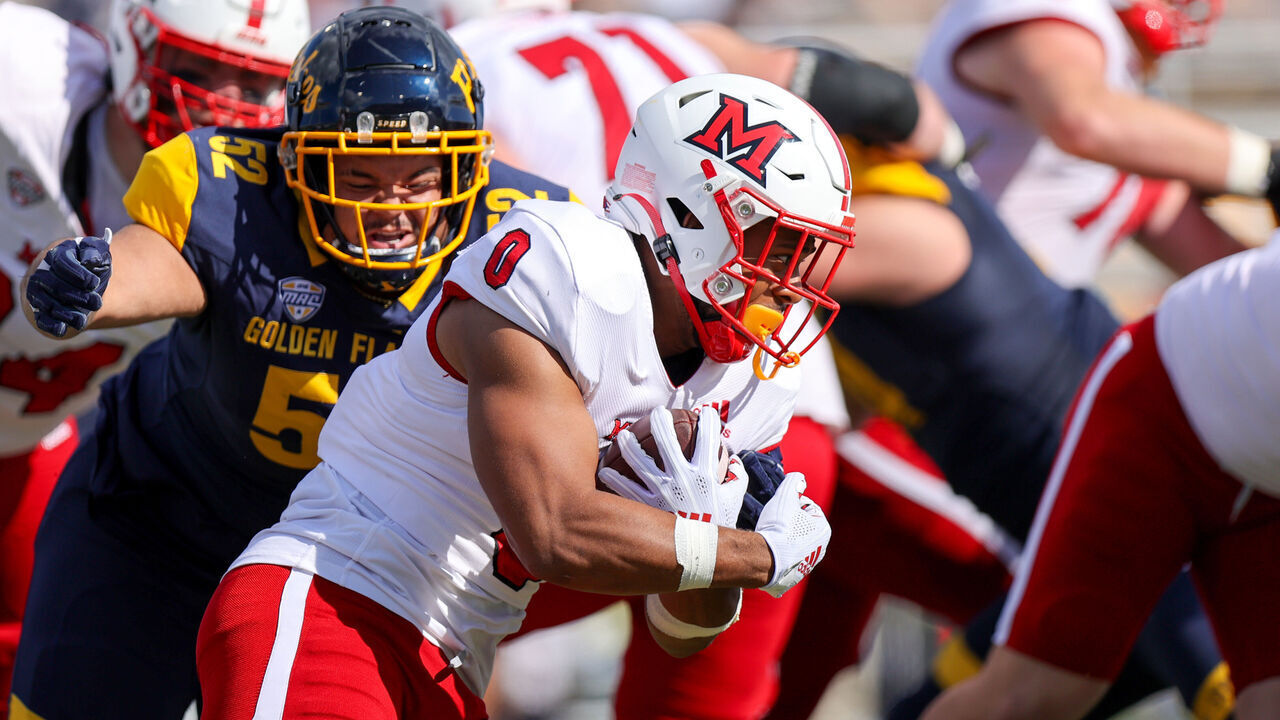 KENT, OH - SEPTEMBER 30: Miami RedHawks running back Rashad Amos (0) is tackled by Kent State Golden Flashes defensive lineman John Jackson (52) during the second quarter of the college football game between the Miami (OH) RedHawks and and Kent State Golden Flashes on September 30, 2023, at Dix Stadium in Kent, OH.
