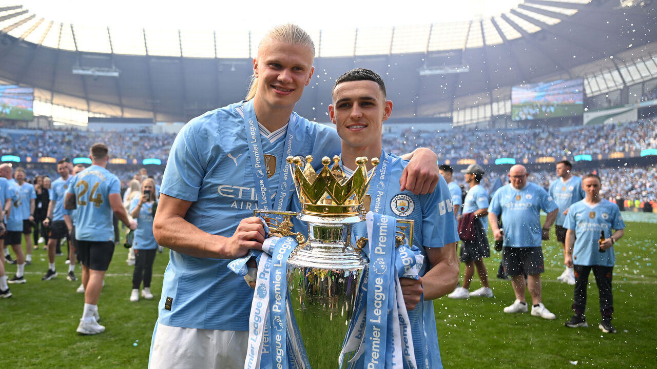 MANCHESTER, ENGLAND - MAY 19: Erling Haaland and Phil Foden of Manchester City pose for a photo with The Premier League Trophy after the Premier League match between Manchester City and West Ham United at Etihad Stadium on May 19, 2024 in Manchester, England.