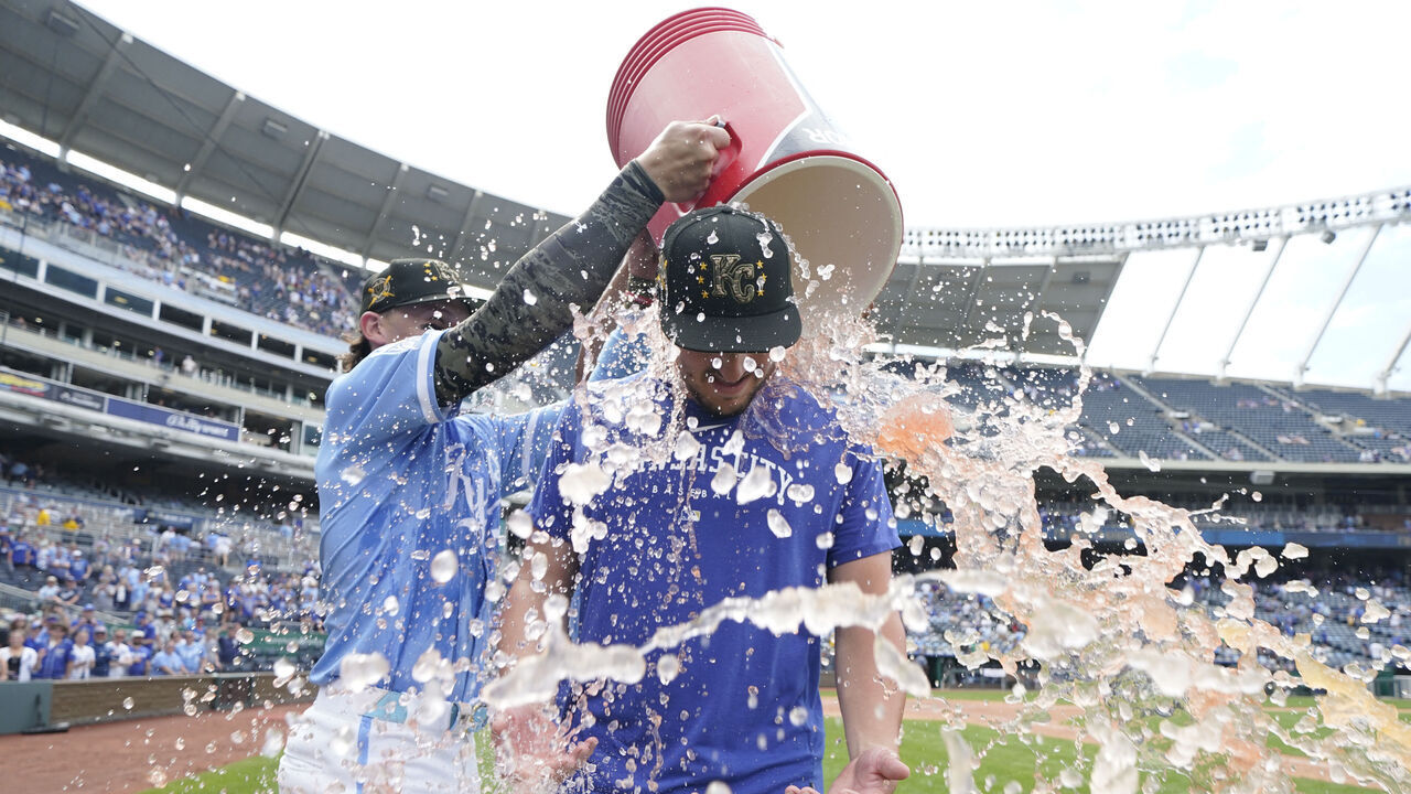 KANSAS CITY, MISSOURI - MAY 19: Vinnie Pasquantino #9 of the Kansas City Royals is doused with water by Bobby Witt Jr. #7 of the Kansas City Royals after an 8-4 win over the Oakland Athletics at Kauffman Stadium on May 19, 2024 in Kansas City, Missouri.