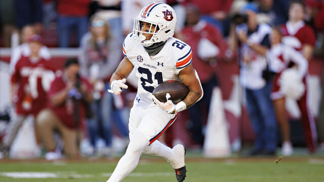FAYETTEVILLE, ARKANSAS - NOVEMBER 11: Brian Battie #21 of the Auburn Tigers runs the ball during the game against the Arkansas Razorbacks at Donald W. Reynolds Razorback Stadium on November 11, 2023 in Fayetteville, Arkansas. The Tigers defeated the Razorbacks 48-10.
