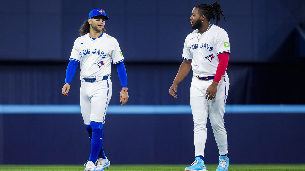 TORONTO, ON - APRIL 10: Bo Bichette #11 and Vladimir Guerrero Jr. #27 of Toronto Blue Jays warm up on the field ahead of playing the Seattle Mariners in their MLB game at the Rogers Centre on April 10, 2024 in Toronto, Ontario, Canada.