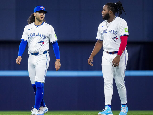 TORONTO, ON - APRIL 10: Bo Bichette #11 and Vladimir Guerrero Jr. #27 of Toronto Blue Jays warm up on the field ahead of playing the Seattle Mariners in their MLB game at the Rogers Centre on April 10, 2024 in Toronto, Ontario, Canada.