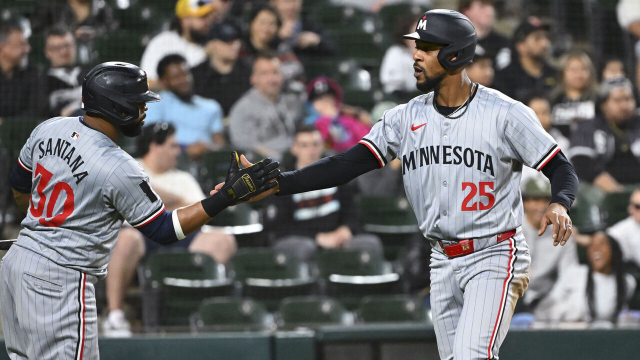 CHICAGO, ILLINOIS - APRIL 29: Byron Buxton #25 of the Minnesota Twins celebrates scoring with Carlos Santana #30 in the ninth inning against the Chicago White Sox at Guaranteed Rate Field on April 29, 2024 in Chicago, Illinois. The Twins defeated the White Sox 3-2.