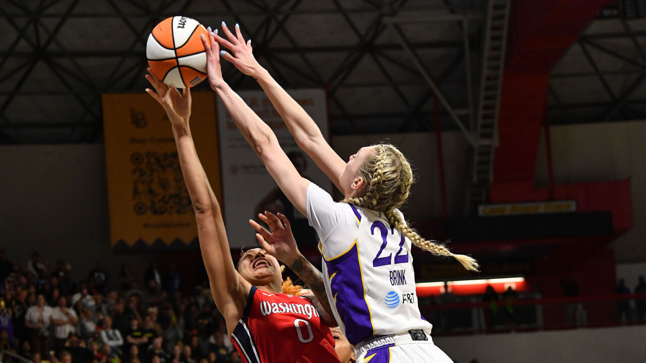 LOS ANGELES, CA - MAY 21: Cameron Brink #22 of the Los Angeles Sparks blocks the shot by Shakira Austin #0 of the Washington Mystics during the game on May 21, 2022 at Walter Pyramid in Long Beach, California. NOTE TO USER: User expressly acknowledges and agrees that, by downloading and/or using this Photograph, user is consenting to the terms and conditions of the Getty Images License Agreement. Mandatory Copyright Notice: Copyright 2023 NBAE