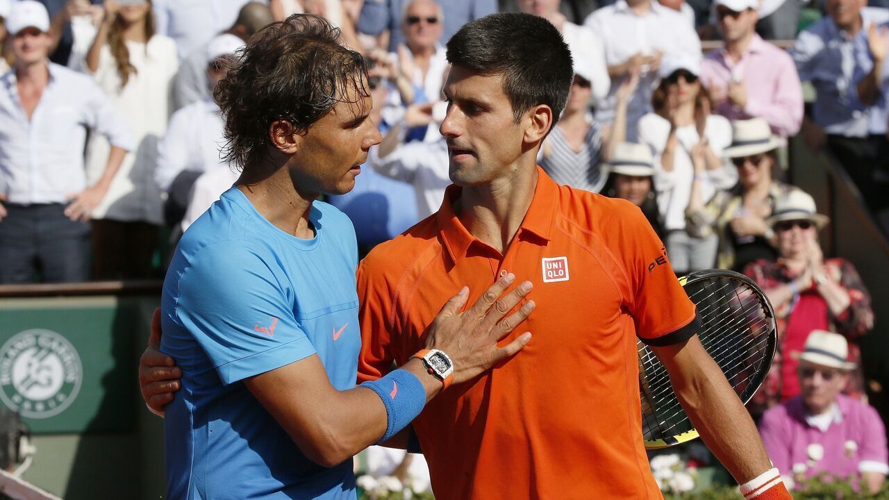 Spain's Rafael Nadal (L) shakes hands with Serbia's Novak Djokovic at the end of their men's quarter final match of the Roland Garros 2015 French Tennis Open in Paris on June 3, 2015. AFP PHOTO / PATRICK KOVARIK
