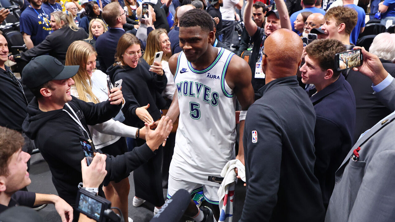 DENVER, COLORADO - MAY 19: Anthony Edwards #5 of the Minnesota Timberwolves high fives fans after defeating the Denver Nuggets in Game Seven of the Western Conference Second Round Playoffs at Ball Arena on May 19, 2024 in Denver, Colorado.