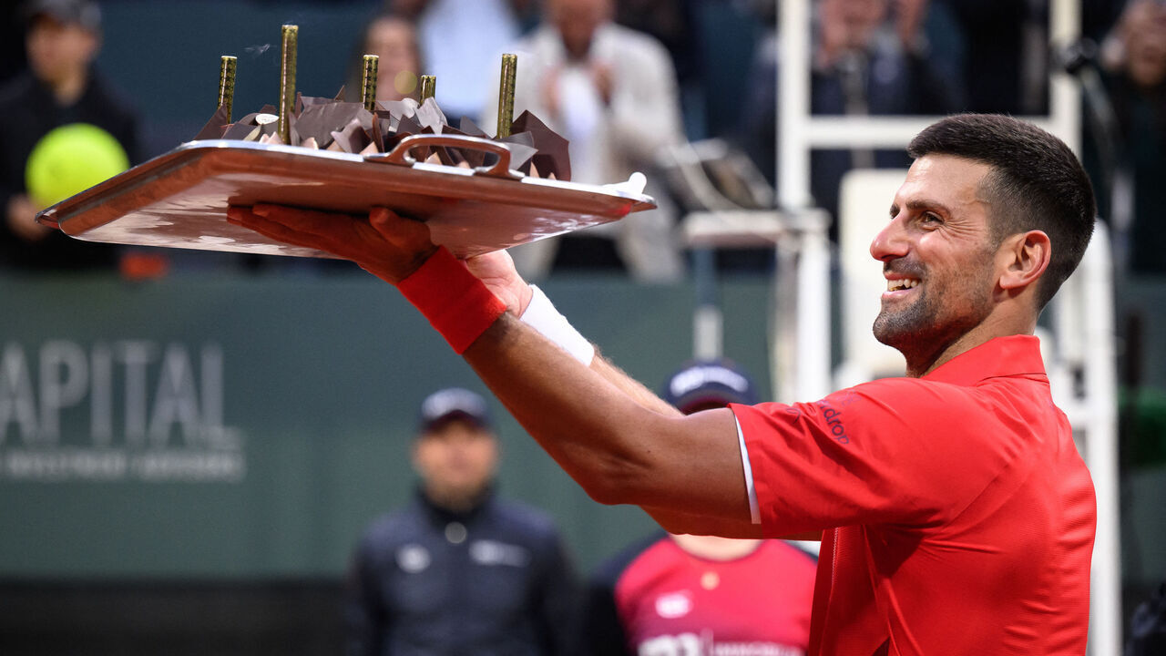 Serbia's Novak Djokovic reacts with his birthday cake after winning his ATP 250 Geneva Open tennis tournament single match against Germany's Yannick Hanfmann, in Geneva, on May 22, 2024.