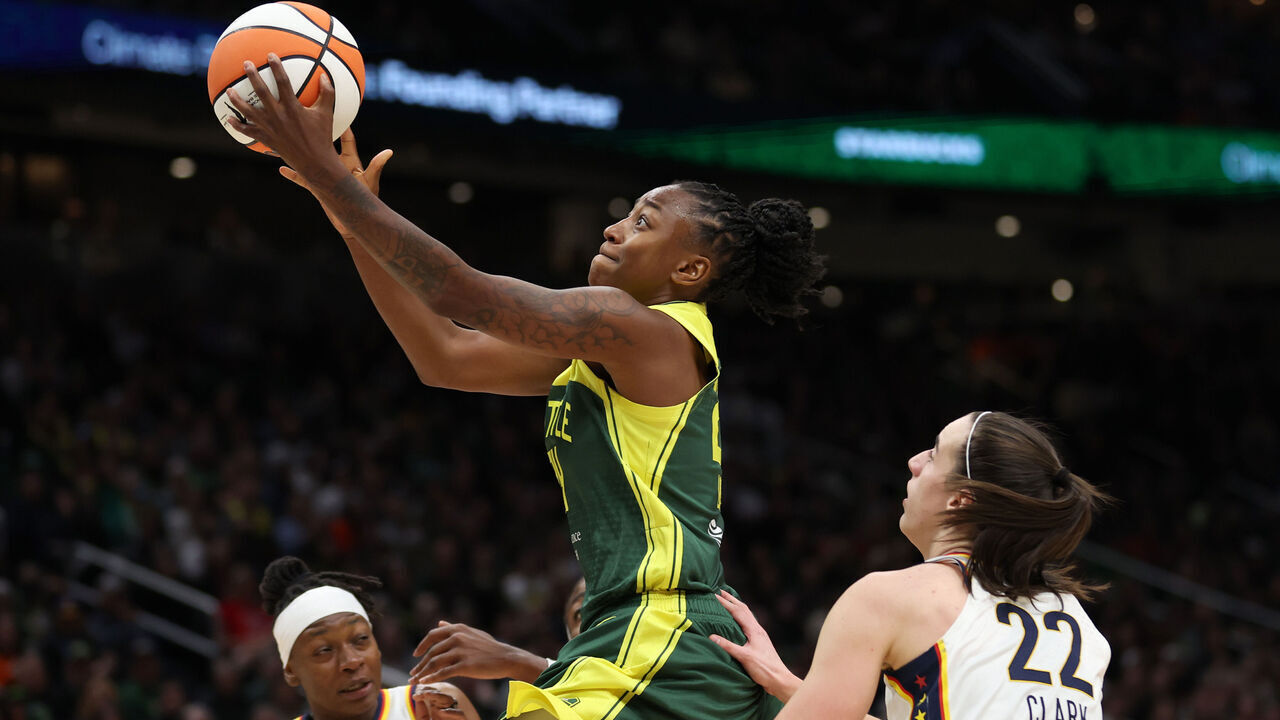 SEATTLE, WASHINGTON - MAY 22: Jewell Loyd #24 of the Seattle Storm drives to the basket against Caitlin Clark #22 of the Indiana Fever during the third quarter in the game at Climate Pledge Arena on May 22, 2024 in Seattle, Washington.