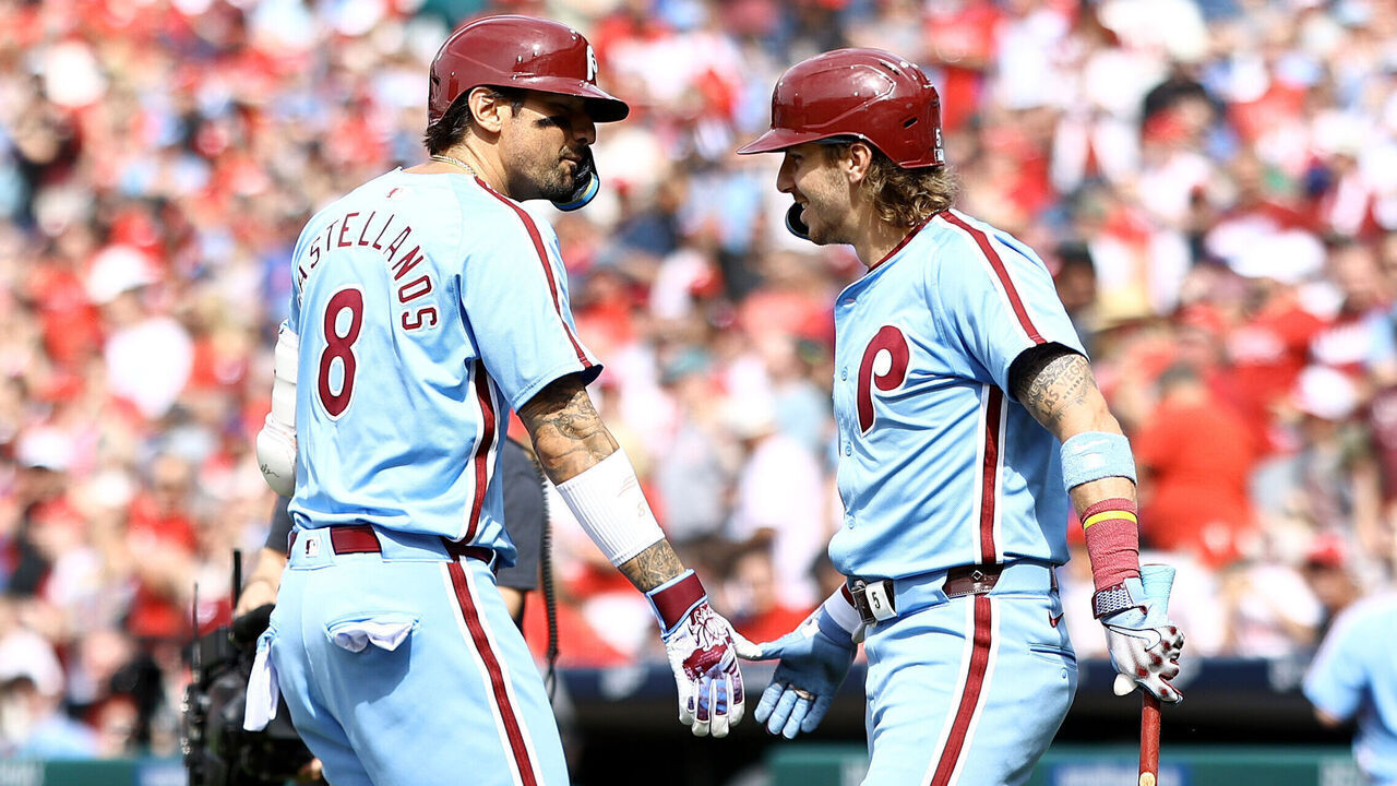 PHILADELPHIA, PENNSYLVANIA - MAY 23: Nick Castellanos #8 and Bryson Stott #5 of the Philadelphia Phillies greet following a solo home run by Castellanos during the seventh inning against the Texas Rangers at Citizens Bank Park on May 23, 2024 in Philadelphia, Pennsylvania.