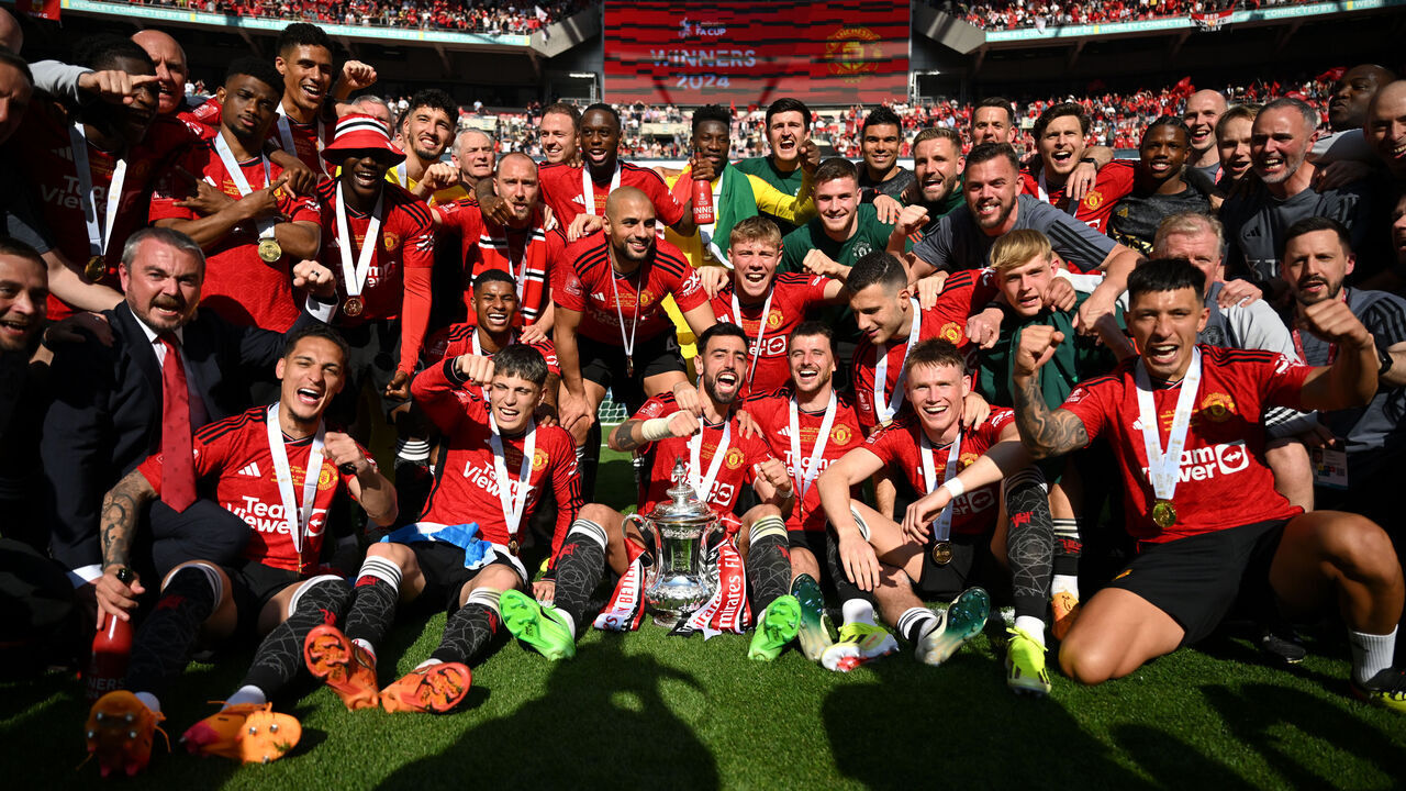 LONDON, ENGLAND - MAY 25: Manchester United players pose for a photograph with the Emirates FA Cup Trophy after his team's victory after the Emirates FA Cup Final match between Manchester City and Manchester United at Wembley Stadium on May 25, 2024 in London, England.