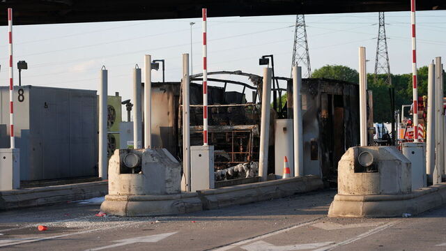 The charred remains of a bus sits at an A1 motorway toll in Fresnes-les-Montauban in Northern France, after a clash occurred on the roadway between supporters of Paris Saint-Germain (PSG) and Olympique Lyonnais (OL) football teams as they were travelling to Villeneuve d'Ascq near Lille for the French Cup football match final, on May 25, 2024. A bus caught fire and 20 participants were lightly injured in clashes between OL and PSG supporters at a motorway toll near Arras, hours before the French cup final opposing the two teams.