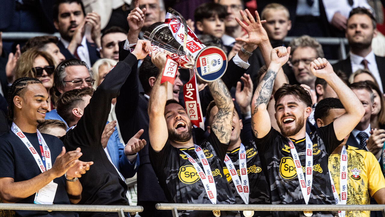 LONDON, ENGLAND - MAY 26: Southampton's Adam Armstrong holds the trophy aloft during the Sky Bet Championship Play-Off Final match between Leeds United and Southampton at Wembley Stadium on May 26, 2024 in London, England.