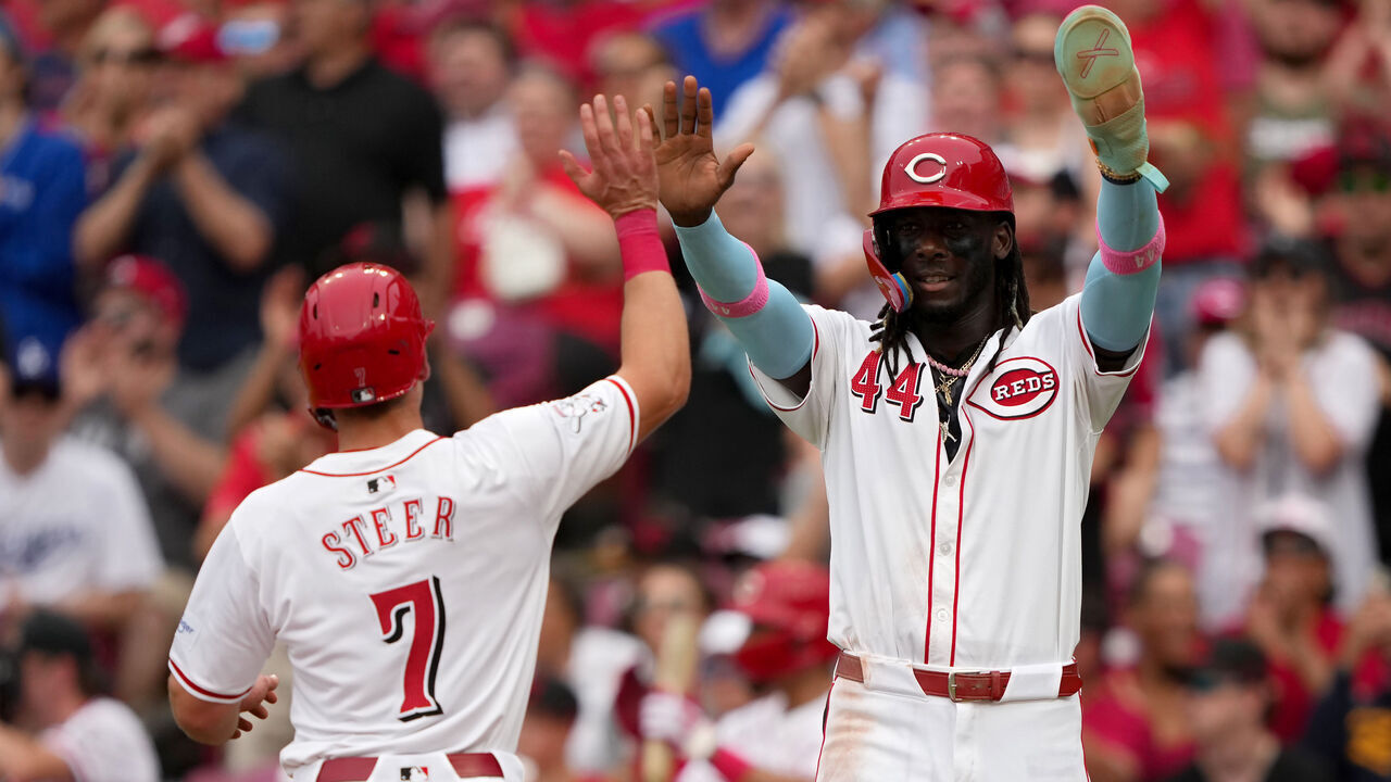 CINCINNATI, OHIO - MAY 26: Spencer Steer #7 and Elly De La Cruz #44 of the Cincinnati Reds celebrate after scoring runs in the third inning against the Los Angeles Dodgers at Great American Ball Park on May 26, 2024 in Cincinnati, Ohio.