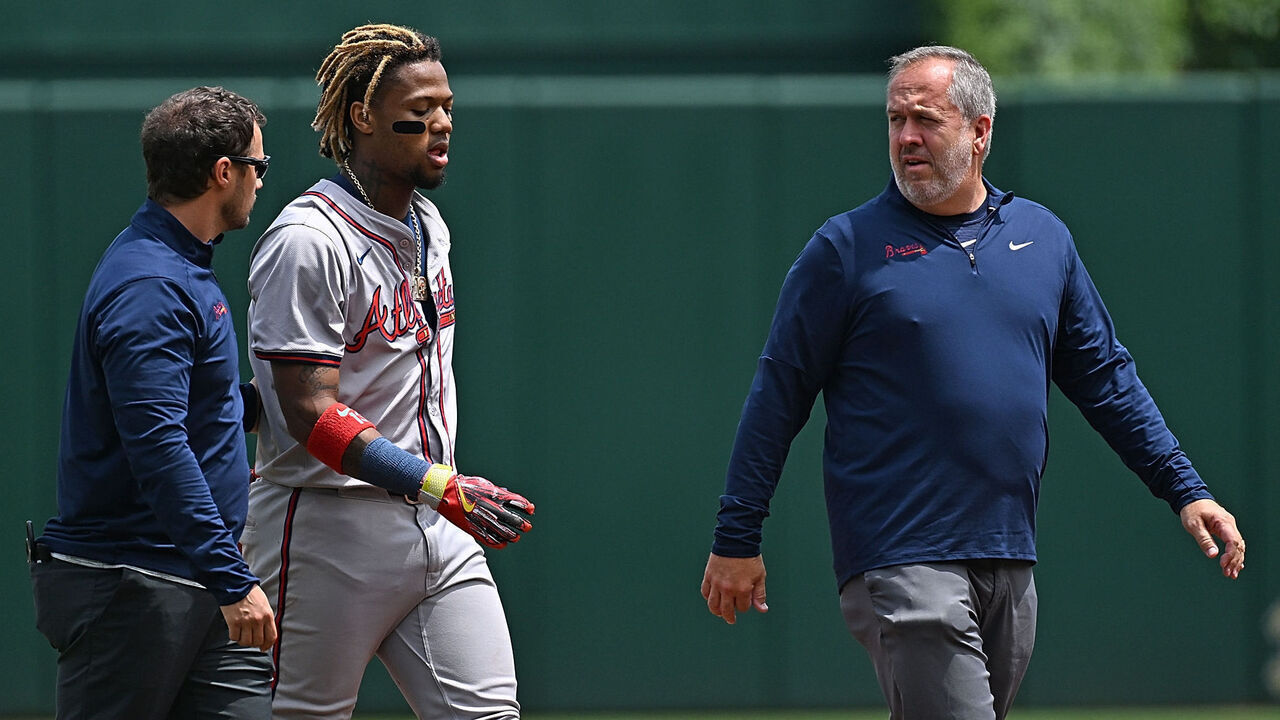 PITTSBURGH, PENNSYLVANIA - MAY 26: Ronald Acuña Jr. #13 of the Atlanta Braves walks off the field with trainers after an apparent injury in the first inning during the game against the Pittsburgh Pirates at PNC Park on May 26, 2024 in Pittsburgh, Pennsylvania.