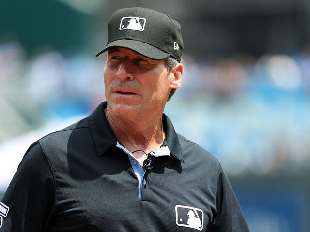KANSAS CITY, MISSOURI - MAY 08: Umpire Angel Hernandez #5 looks on prior to the game between the Milwaukee Brewers and the Kansas City Royals at Kauffman Stadium on May 08, 2024 in Kansas City, Missouri.