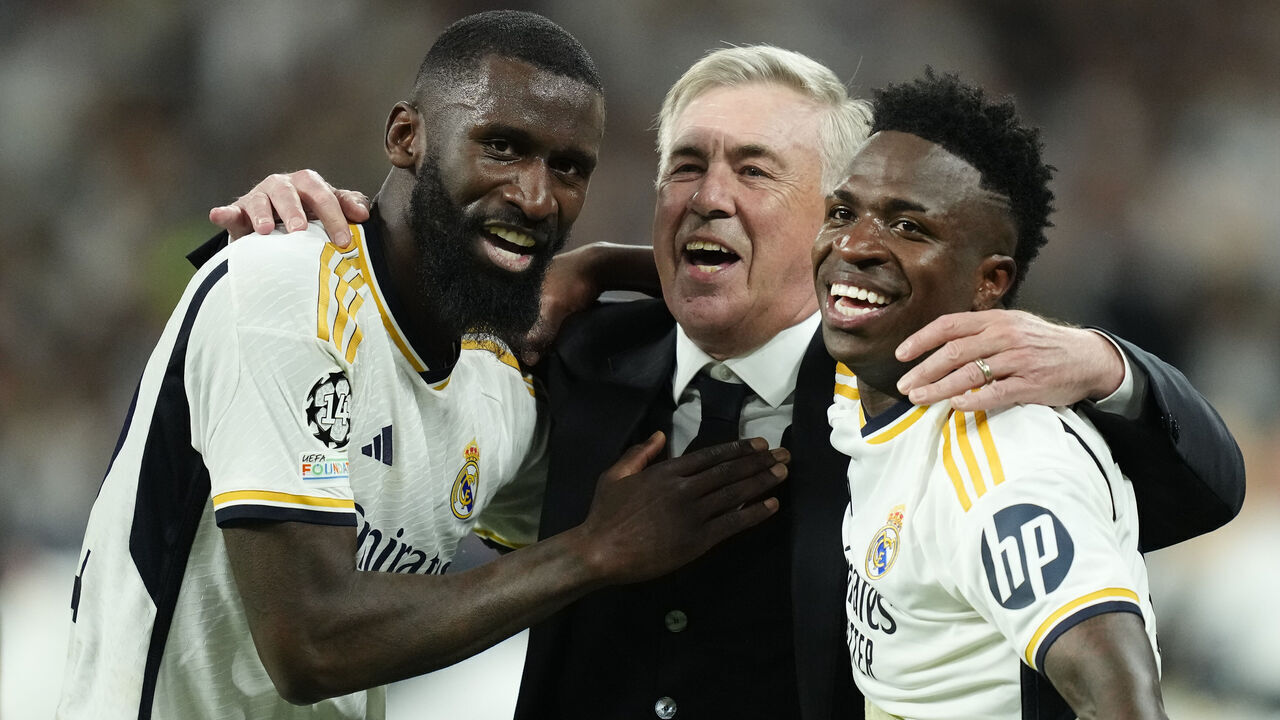 (L-R) Antonio Rudiger centre-back of Real Madrid and Germany , Carlo Ancelotti head coach of Real Madrid and Vinicius Junior left winger of Real Madrid and Brazil celebrates victory after the UEFA Champions League semi-final second leg match between Real Madrid and FC Bayern München at Estadio Santiago Bernabeu on May 8, 2024 in Madrid, Spain.