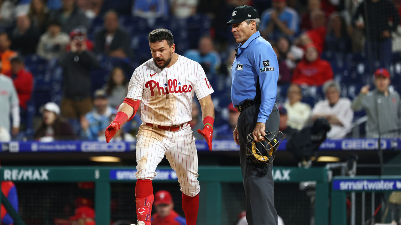 PHILADELPHIA, PA - APRIL 24: Kyle Schwarber #12 of the Philadelphia Phillies argues with home plate umpire Angel Hernandez after being called out on a third strike during the ninth inning of a game against the Milwaukee Brewers at Citizens Bank Park on April 24, 2022 in Philadelphia, Pennsylvania. The Brewers defeated the Phillies 1-0.