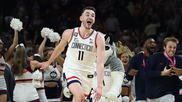 GLENDALE, ARIZONA - APRIL 08: Alex Karaban #11 of the Connecticut Huskies celebrates after beating the Purdue Boilermakers 75-60 to win the NCAA Men's Basketball Tournament National Championship game at State Farm Stadium on April 08, 2024 in Glendale, Arizona.