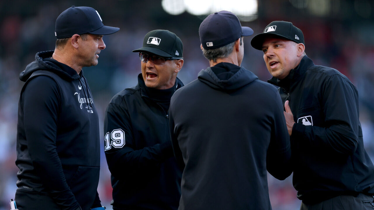 ANAHEIM, CALIFORNIA - MAY 29: Manager Aaron Boone #17 of the New York Yankees argues a runner's interference call on Juan Soto #22, with umpires Vic Carapazza #19 and Adam Hamari #78 during the first inning at Angel Stadium of Anaheim on May 29, 2024 in Anaheim, California.