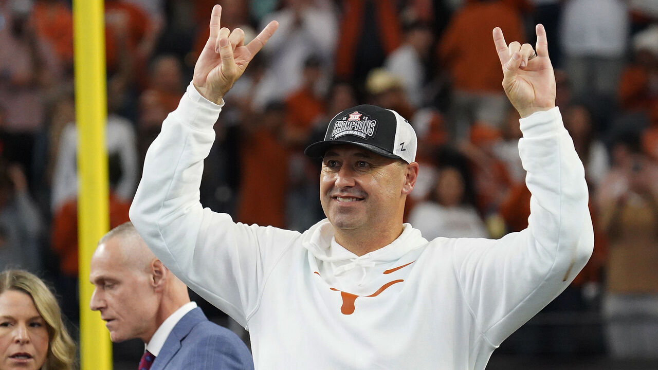 December 2, 2023, Arlington, Texas, United States: Texas Longhorns coach Steve Sarkisian makes the Hook 'Em Horns sign after defeating Oklahoma State and winning the 2023 Dr Pepper Big 12 Championship after the match between Texas Longhorns and Oklahoma State Cowboys.