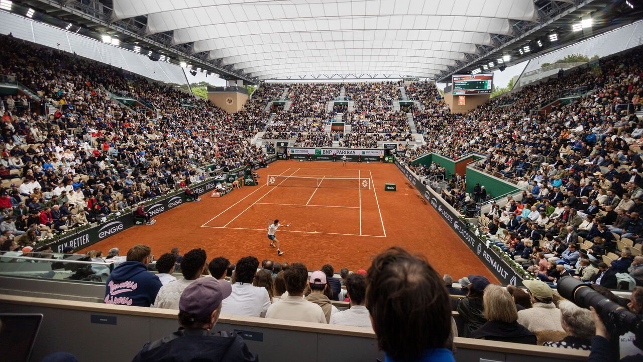 PARIS, FRANCE - MAY 28. A general view of Tomas Martin Etcheverry of Argentina in action against Arthur Cazaux of France on Court Suzanne Lenglen with the roof closed during the first round of the 2024 French Open Tennis Tournament at Roland Garros on May 28th, 2024, in Paris, France.