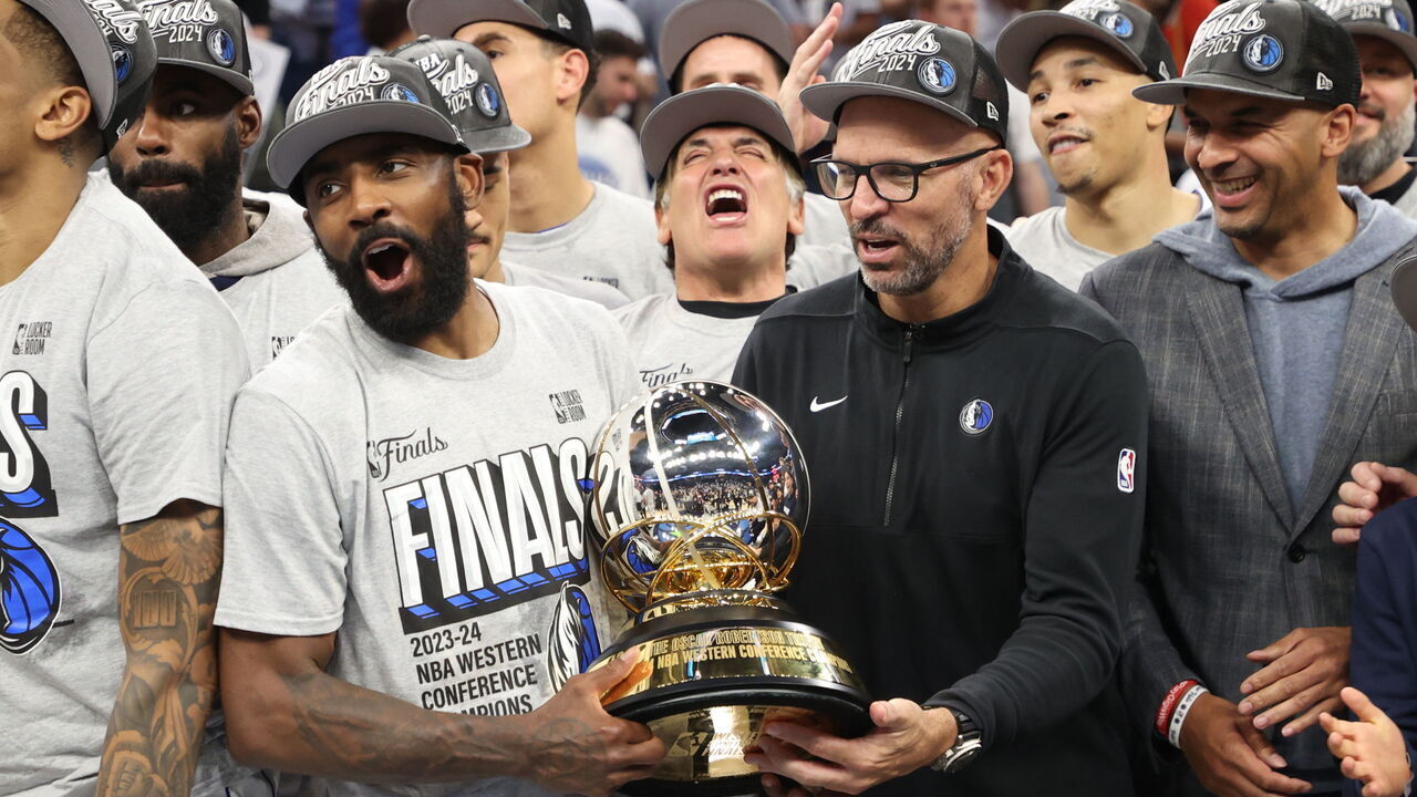 MINNEAPOLIS, MN - MAY 30: Kyrie Irving #11 of the Dallas Mavericks celebrates with the Oscar Robertson Trophy after winning the Western Conference Finals during Round 3 Game 5 of the 2024 NBA Playoffs on May 30, 2024 at Target Center in Minneapolis, Minnesota. Mandatory Copyright Notice: Copyright 2024 NBAE
