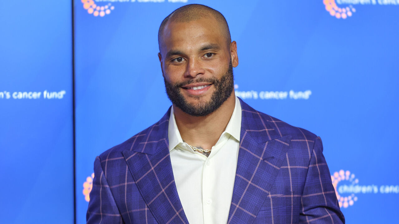 FRISCO, TX - MAY 22: Dallas Cowboys quarterback Dak Prescott (4) presents a check for $2.1 million to the Children's Cancer Fund following the Dallas Cowboys OTAs on May 22, 2024 at The Star in Frisco, TX.