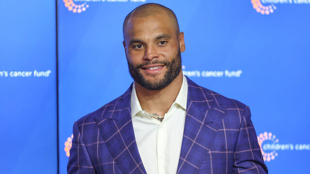 FRISCO, TX - MAY 22: Dallas Cowboys quarterback Dak Prescott (4) presents a check for $2.1 million to the Children's Cancer Fund following the Dallas Cowboys OTAs on May 22, 2024 at The Star in Frisco, TX.