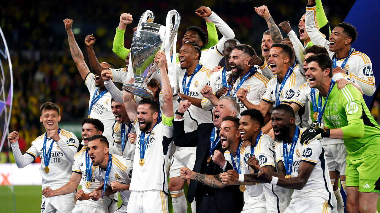 Real Madrid's Nacho Fernandez lifts the trophy as he celebrates winning the UEFA Champions League final with manager Carlo Ancelotti and team-mates at Wembley Stadium in London. Picture date: Saturday June 1, 2024.