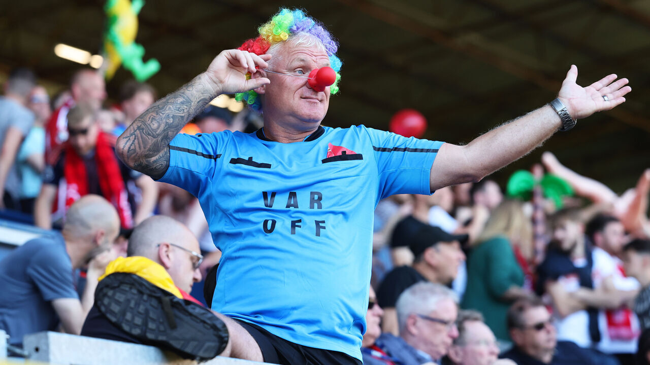 BURNLEY, ENGLAND - MAY 19: A fan of Nottingham Forest wearing clown accessories and a t-shirt displaying the text "VAR Off" reacts during the Premier League match between Burnley FC and Nottingham Forest at Turf Moor on May 19, 2024 in Burnley, England.