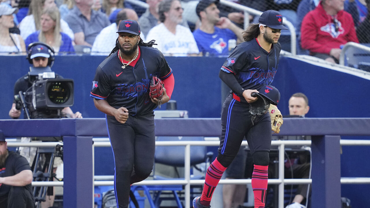 TORONTO, ON - MAY 31: Vladimir Guerrero Jr. #27 and Bo Bichette #11 of the Toronto Blue Jays take the field against the Pittsburgh Pirates in their MLB game at the Rogers Centre on May 31, 2024 in Toronto, Ontario, Canada.