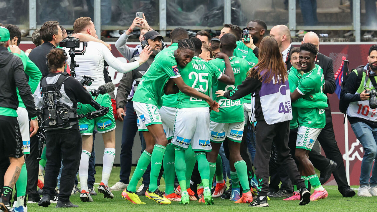 Saint-Etienne's players celebrate with supporters their victory at the end of the French L1-L2 playoff football match between FC Metz and AS Saint-Etienne at the Saint-Symphorien Stadium in Longeville-les-Metz, eastern France on June 2, 2024. The match ended 2-2 and Saint-Etienne will join again the L1.