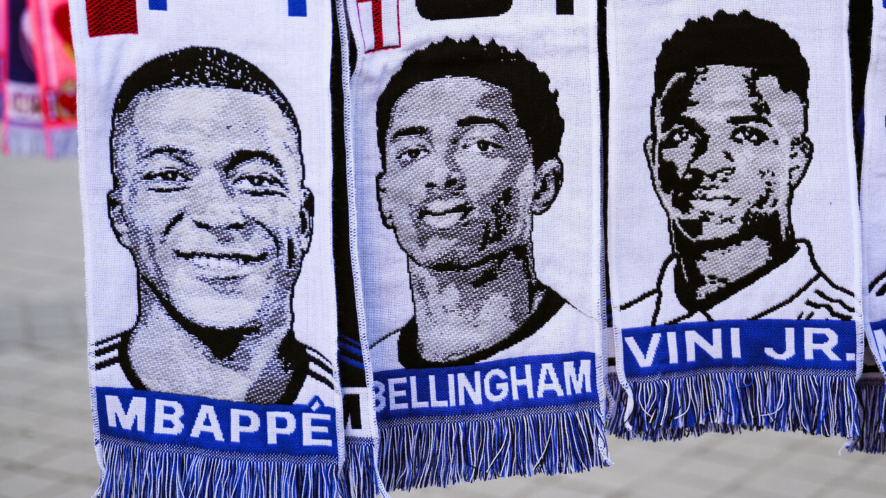 MADRID, SPAIN - MARCH 06: Scarves of Kylian Mbappe, Jude Bellingham and Vinicius Jr.hang in a souvenir stall outside the stadium prior to the UEFA Champions League 2023/24 round of 16 second leg match between Real Madrid CF and RB Leipzig at Estadio Santiago Bernabeu on March 06, 2024 in Madrid, Spain.