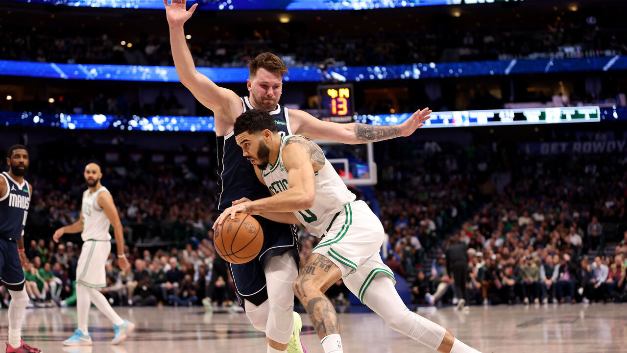 DALLAS, TEXAS - JANUARY 22: Jayson Tatum #0 of the Boston Celtics goes to the basket against Luka Doncic #77 of the Dallas Mavericks in the second half at American Airlines Center on January 22, 2024 in Dallas, Texas.
