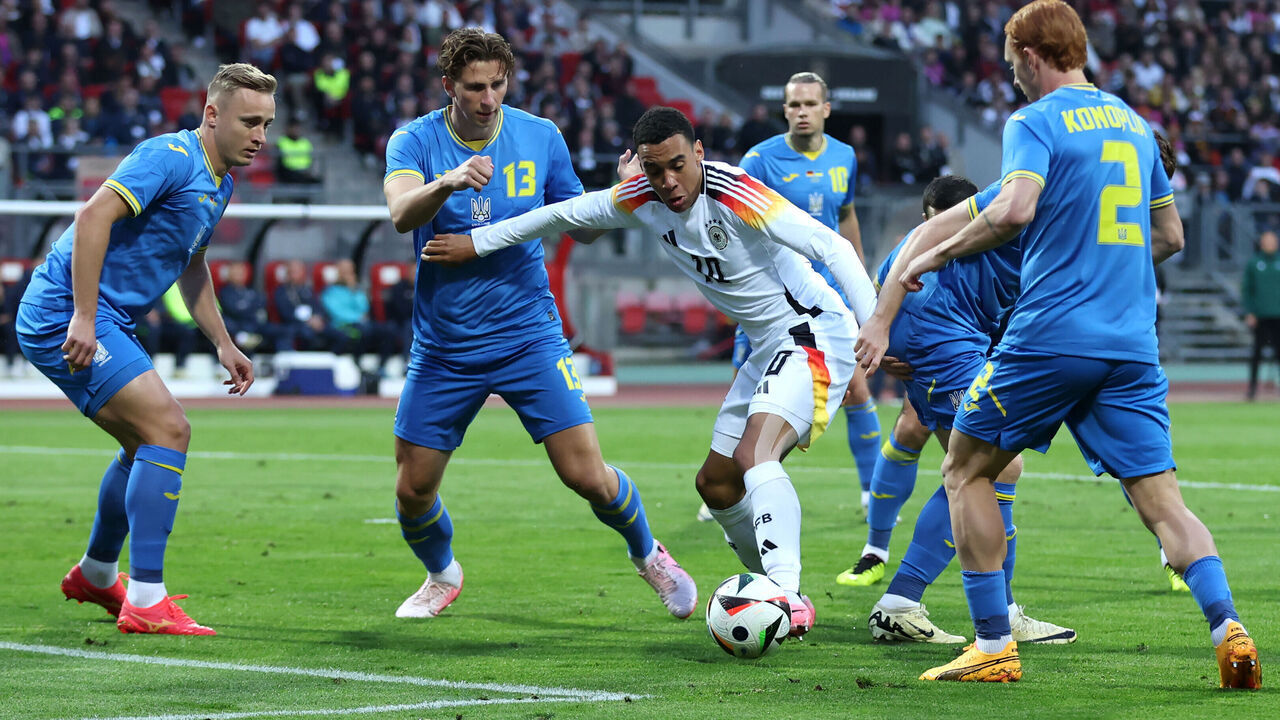 NUREMBERG, GERMANY - JUNE 03: Jamal Musiala of Germany is challenged by Illia Zabarnyi of Ukraine during the international friendly match between Germany and Ukraine at Max-Morlock-Stadion on June 03, 2024 in Nuremberg, Germany.