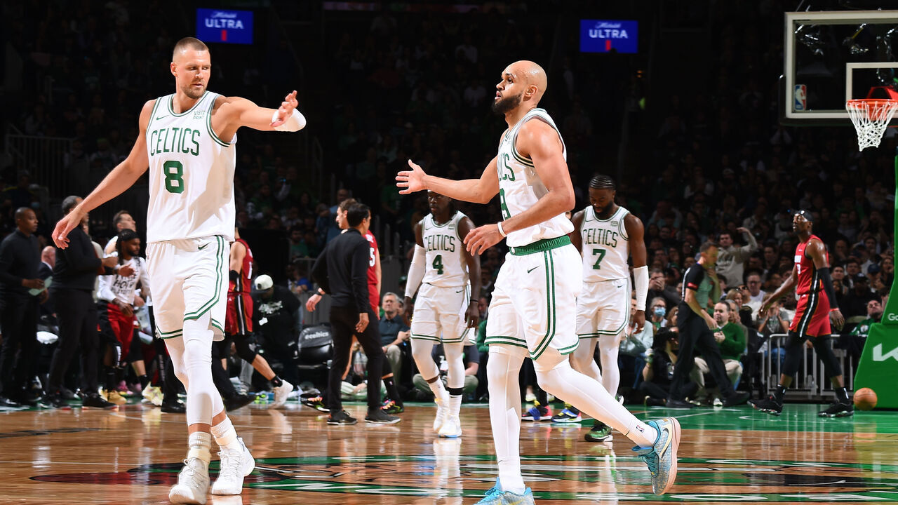BOSTON, MA - APRIL 21: Kristaps Porzingis #8 high fives Derrick White #9 of the Boston Celtics during the game against the Miami Heat during Round 1 Game 1 of the 2024 NBA Playoffs on April 21, 2024 at the TD Garden in Boston, Massachusetts. Mandatory Copyright Notice: Copyright 2024 NBAE