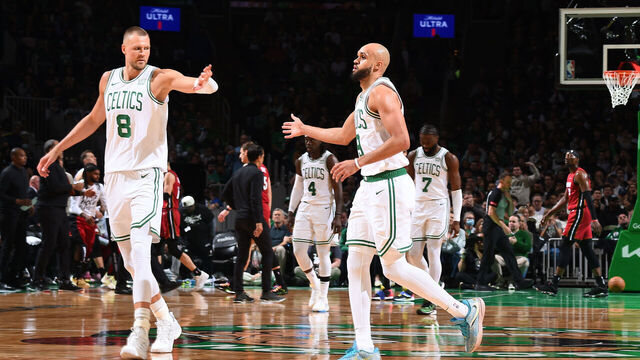 BOSTON, MA - APRIL 21: Kristaps Porzingis #8 high fives Derrick White #9 of the Boston Celtics during the game against the Miami Heat during Round 1 Game 1 of the 2024 NBA Playoffs on April 21, 2024 at the TD Garden in Boston, Massachusetts. Mandatory Copyright Notice: Copyright 2024 NBAE
