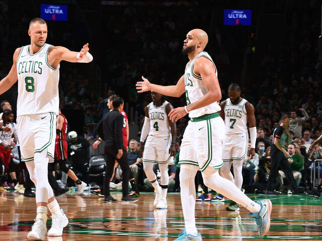 BOSTON, MA - APRIL 21: Kristaps Porzingis #8 high fives Derrick White #9 of the Boston Celtics during the game against the Miami Heat during Round 1 Game 1 of the 2024 NBA Playoffs on April 21, 2024 at the TD Garden in Boston, Massachusetts. Mandatory Copyright Notice: Copyright 2024 NBAE