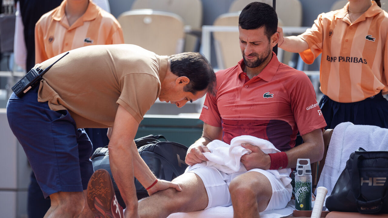 PARIS, FRANCE - June 03: Novak Djokovic of Serbia receives treatment for his knee injury during his match against Francisco Cerundolo of Argentina on Court Philippe-Chatrier during the fourth round of the 2024 French Open Tennis Tournament at Roland Garros on June 3rd, 2024, in Paris, France.