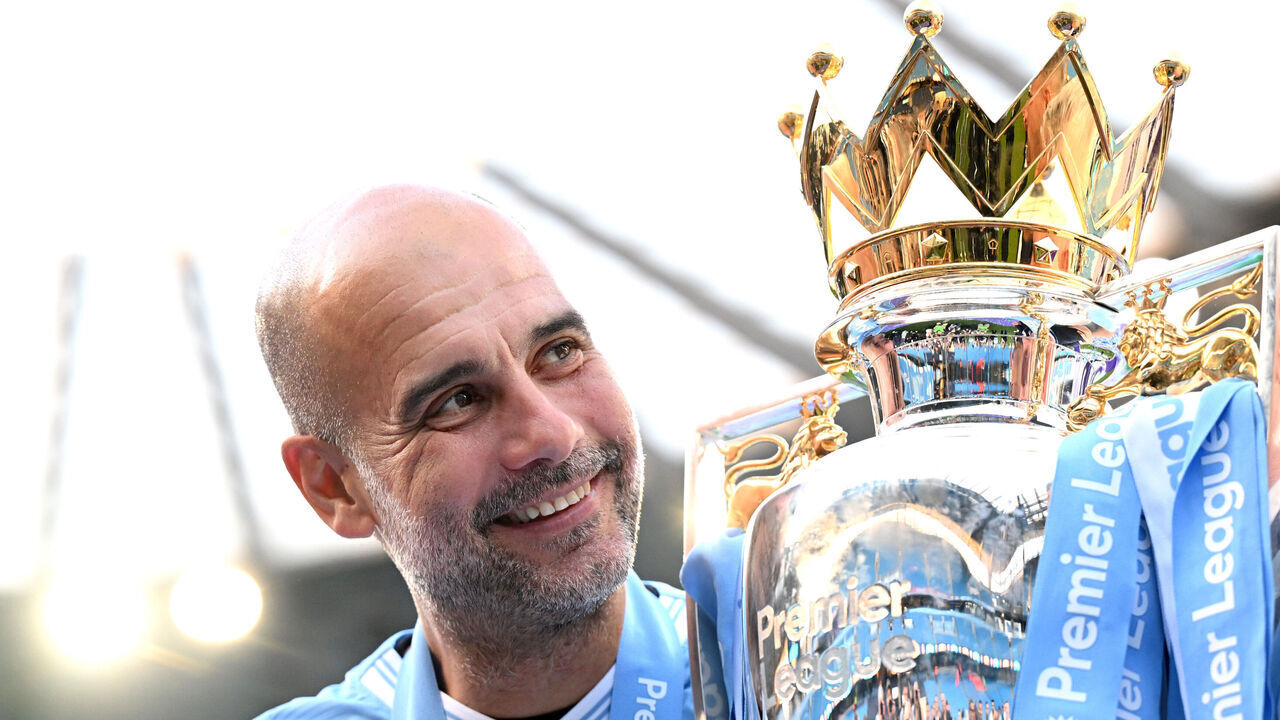MANCHESTER, ENGLAND - MAY 19: Pep Guardiola, Manager of Manchester City, poses for a photo with the Premier League title trophy following the team's victory in the Premier League match between Manchester City and West Ham United at Etihad Stadium on May 19, 2024 in Manchester, England.