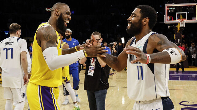 Los Angeles, CA, Wednesday, November 22, 2023 - Los Angeles Lakers forward LeBron James (23) and Dallas Mavericks guard Kyrie Irving (11) embrace at midcourt after the Mavericks beat the Lakers 104-101 at Crypto.Com Arena. (Robert Gauthier/Los Angeles Times via Getty Images)