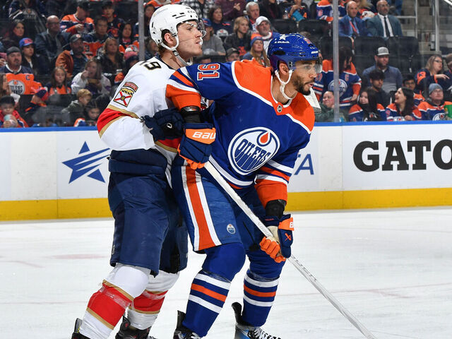 EDMONTON, CANADA - DECEMBER 16: Evander Kane #91 of the Edmonton Oilers and Matthew Tkachuk #19 of the Florida Panthers battle for position during the game at Rogers Place on December 16, 2023, in Edmonton, Alberta, Canada.