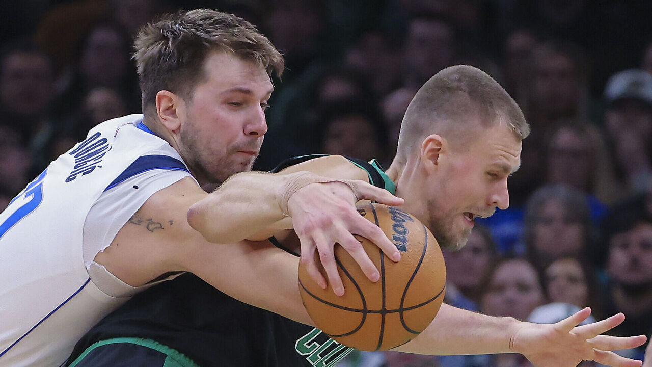 Boston, MA - March 1: Boston Celtics center Kristaps Porzingis dribbles with pressure from Dallas Mavericks guard Luka Doncic in the third quarter. The Celtics beat the Mavericks, 138-110.