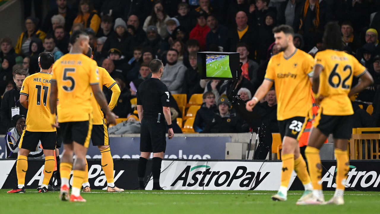 WOLVERHAMPTON, ENGLAND - APRIL 24: Referee Stuart Attwell checks the VAR monitor before disallowing the goal scored by Hwang Hee-Chan of Wolverhampton Wanderers (not pictured) following a foul in the build up by Matheus Cunha of Wolverhampton Wanderers during the Premier League match between Wolverhampton Wanderers and AFC Bournemouth at Molineux on April 24, 2024 in Wolverhampton, England.